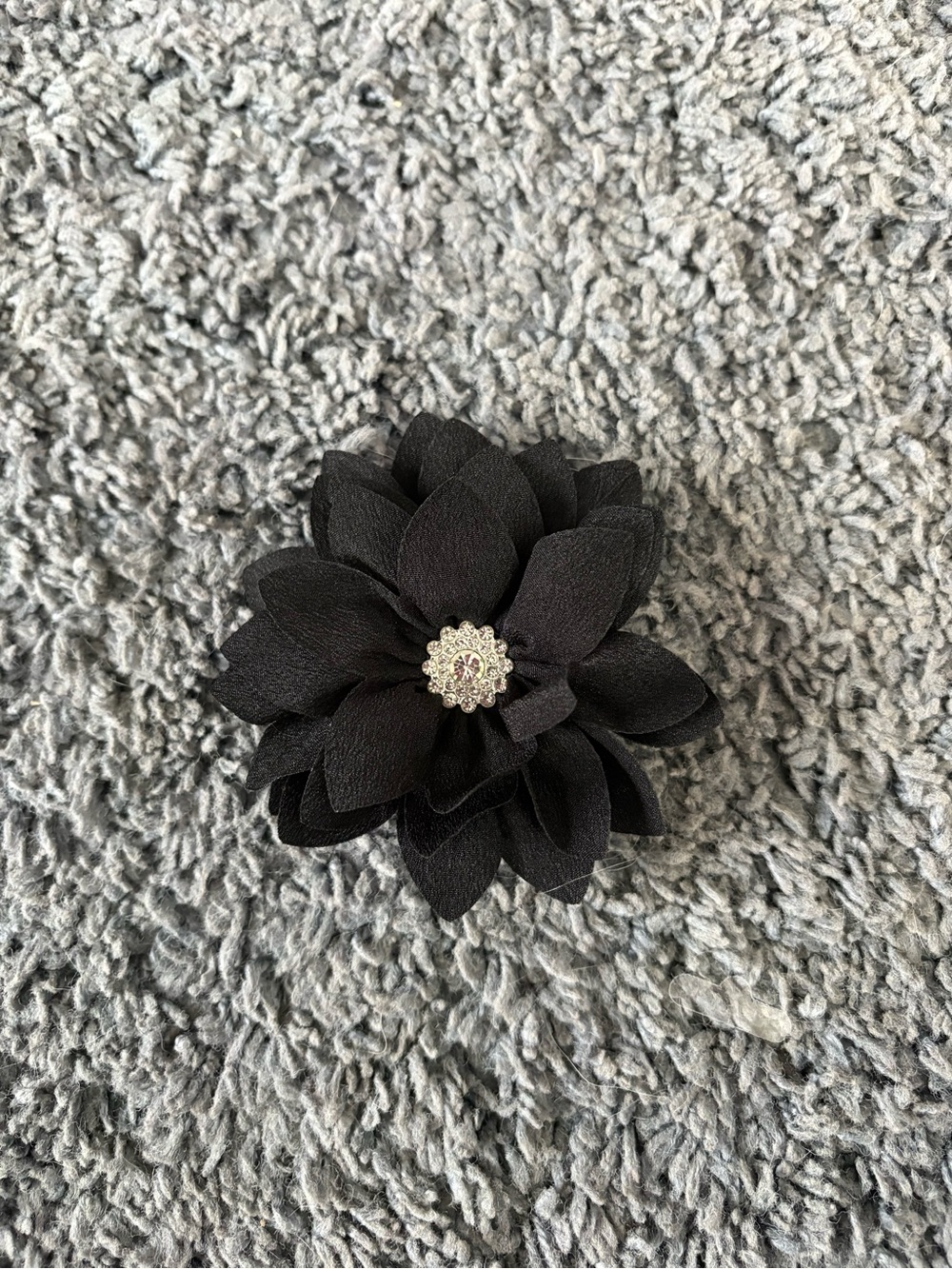 NWOT black flower with CZ stones in the center air clip